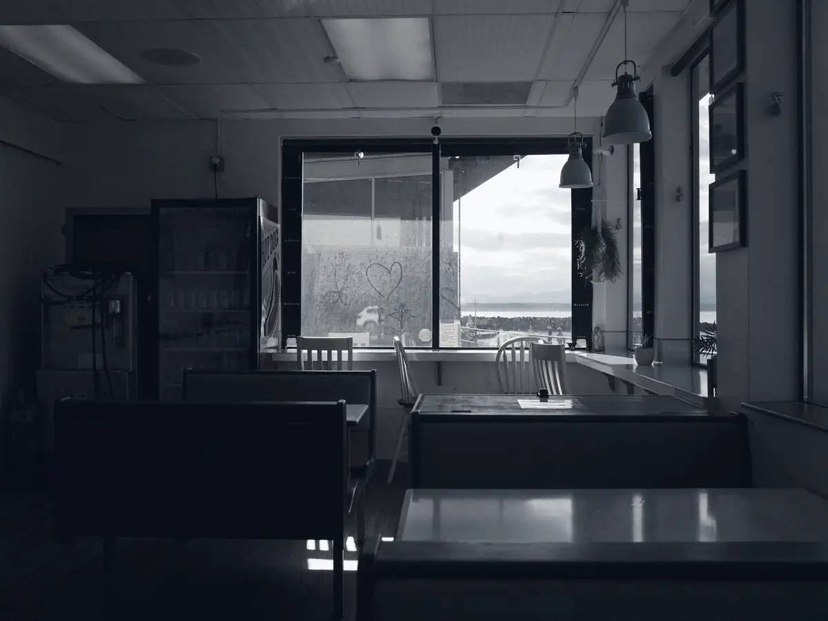 Open workspace with desks and large windows after hours